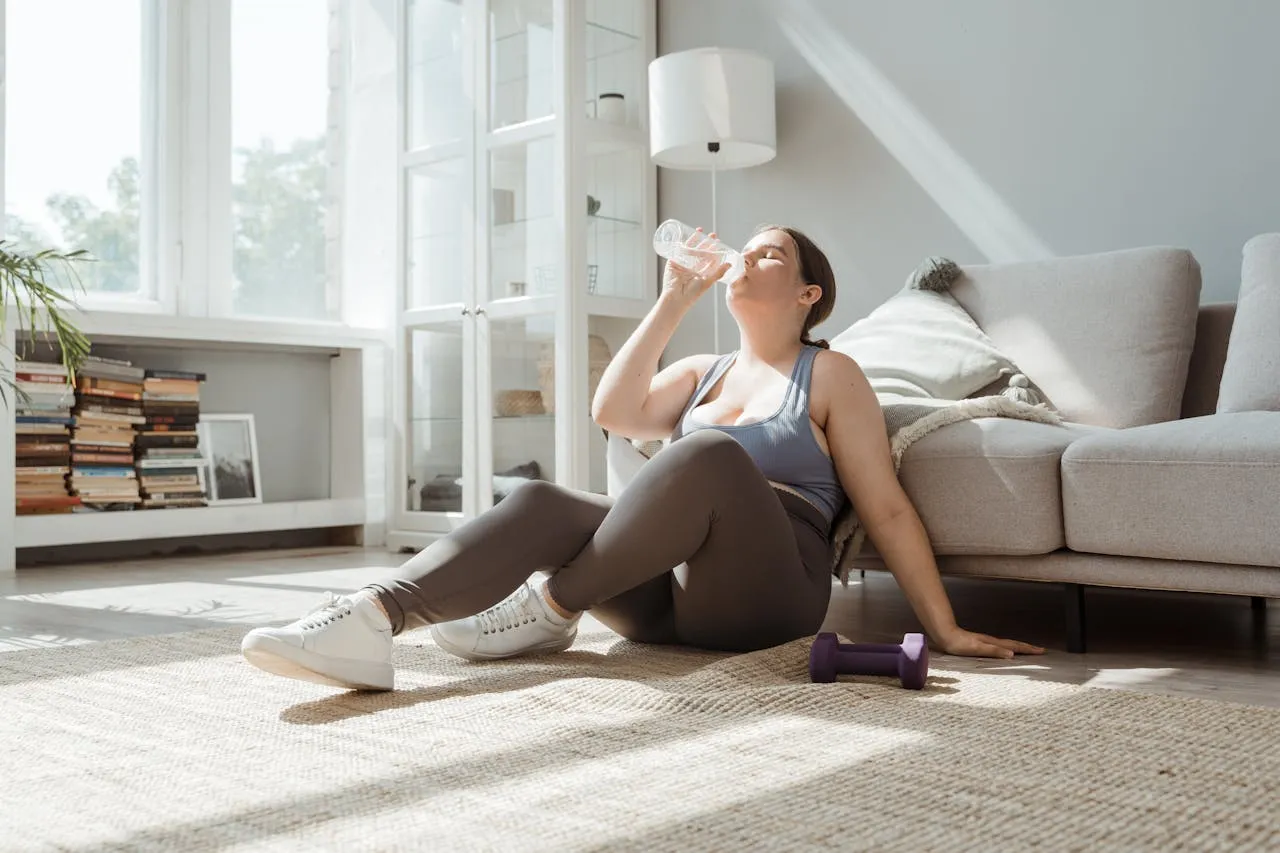 Woman exercising at home with fresh fruits and vegetables on the table, symbolizing natural and healthy weight loss methods at home.