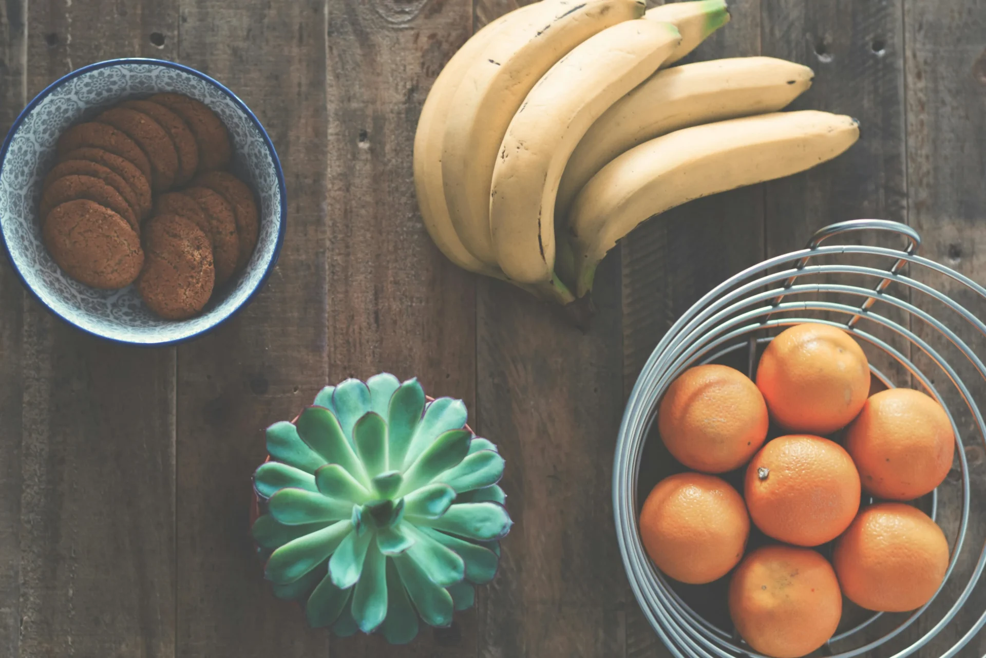 Ripe yellow bananas on a wooden table with a nutrition label graphic, representing the proven health benefits of bananas backed by science and experts.