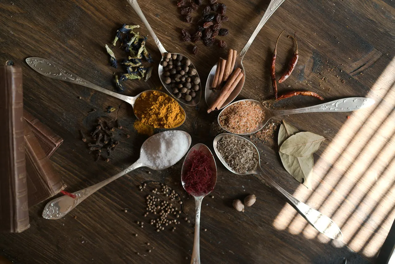 Wooden spoon with black pepper sprinkled over turmeric, highlighting its wellness-boosting benefits.