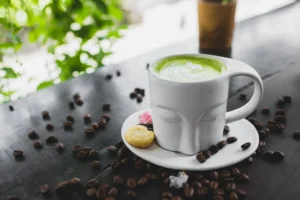 Steaming cup of green tea with fresh leaves, showcasing science-backed health benefits