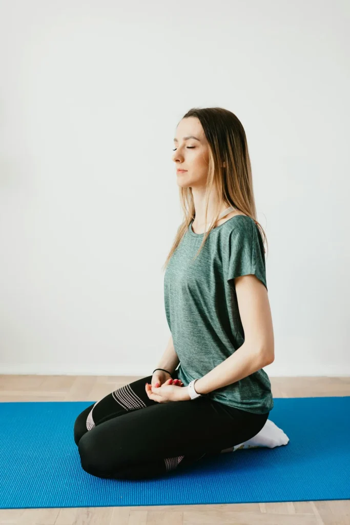 Woman practicing gentle yoga poses to relieve period cramps at home.