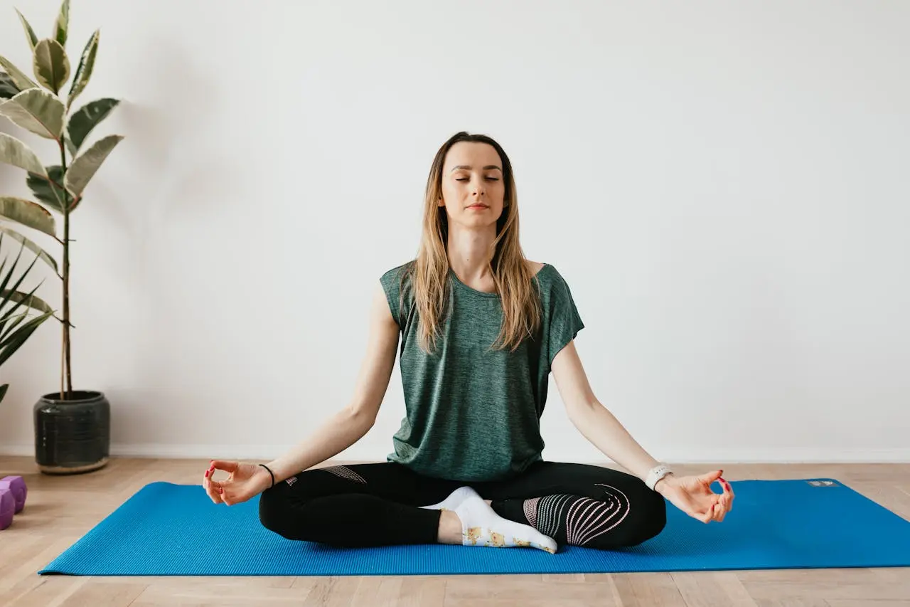 Woman doing relaxing yoga poses to relieve menstrual cramps at home.